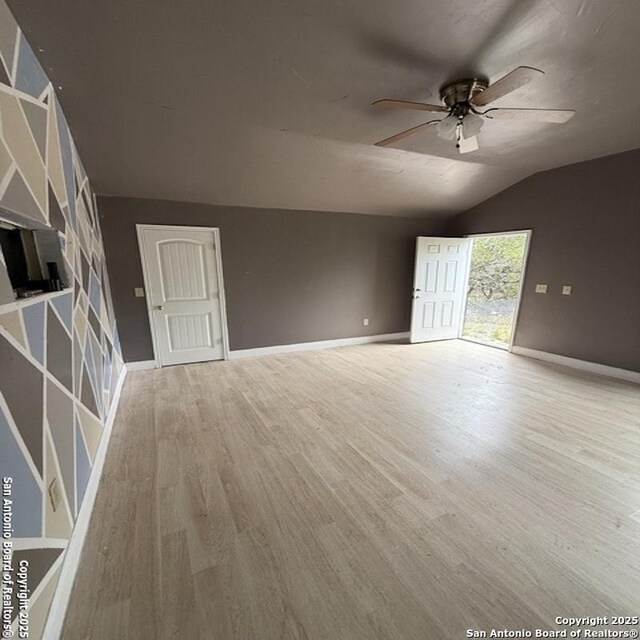 28 28th, Lakehills, TX 78063 - unfurnished living room featuring a ceiling fan, wood finished floors, baseboards, and lofted ceiling