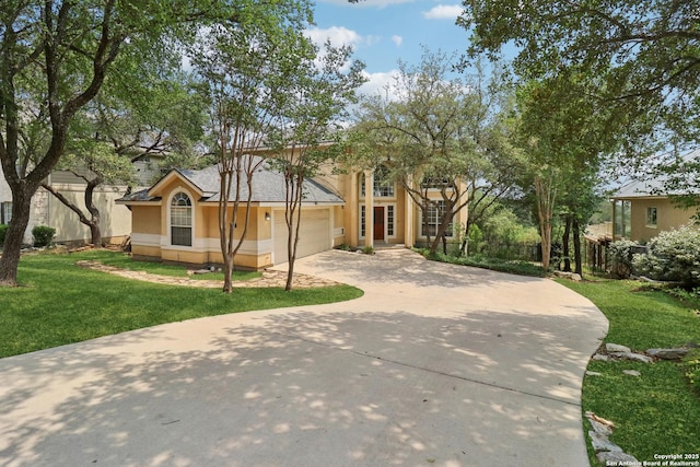 522 Mesa Rdg, San Antonio, TX 78258 - view of front of house with concrete driveway, a front yard, stucco siding, and a garage