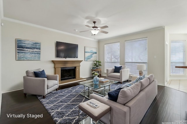 522 Mesa Rdg, San Antonio, TX 78258 - living room with ceiling fan, baseboards, crown molding, dark wood-style flooring, and a fireplace with raised hearth