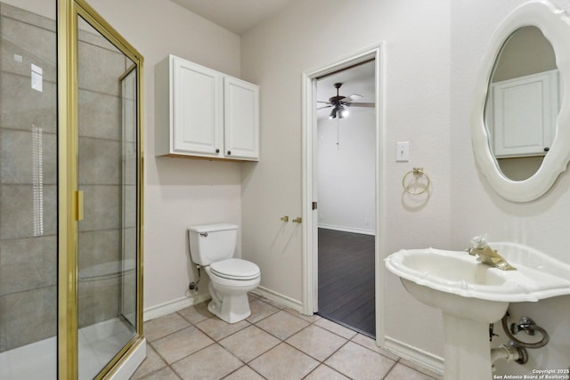 522 Mesa Rdg, San Antonio, TX 78258 - full bath with ceiling fan, a stall shower, toilet, tile patterned flooring, and baseboards
