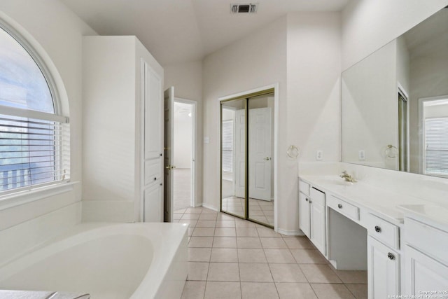522 Mesa Rdg, San Antonio, TX 78258 - bathroom with vanity, a garden tub, tile patterned floors, and baseboards