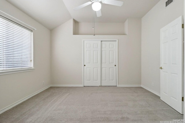 522 Mesa Rdg, San Antonio, TX 78258 - unfurnished bedroom featuring vaulted ceiling, light carpet, a closet, and baseboards