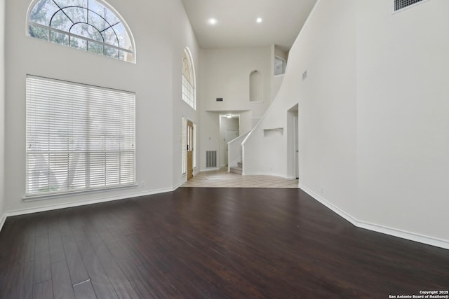 522 Mesa Rdg, San Antonio, TX 78258 - unfurnished living room featuring a high ceiling, wood finished floors, stairs, baseboards, and recessed lighting