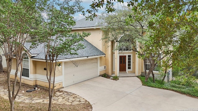 522 Mesa Rdg, San Antonio, TX 78258 - view of front of house featuring roof with shingles, stucco siding, and concrete driveway
