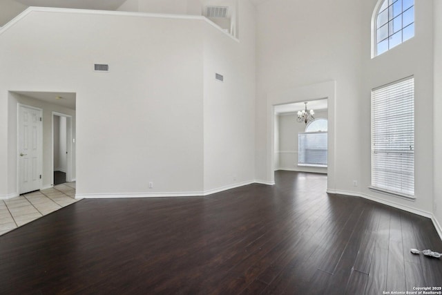 522 Mesa Rdg, San Antonio, TX 78258 - unfurnished living room featuring high vaulted ceiling, a chandelier, healthy amount of natural light, hardwood / wood-style flooring, and baseboards