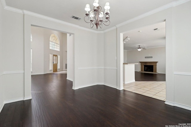 522 Mesa Rdg, San Antonio, TX 78258 - unfurnished dining area featuring ceiling fan, a fireplace with raised hearth, wood finished floors, and ornamental molding