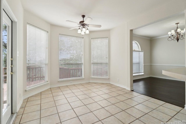 522 Mesa Rdg, San Antonio, TX 78258 - unfurnished dining area with light tile patterned floors, a chandelier, ceiling fan, baseboards, and ornamental molding