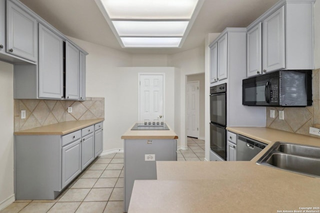 522 Mesa Rdg, San Antonio, TX 78258 - kitchen featuring black appliances, a center island, decorative backsplash, light tile patterned floors, and light countertops
