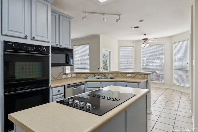 522 Mesa Rdg, San Antonio, TX 78258 - kitchen featuring a sink, black appliances, a ceiling fan, a peninsula, and light tile patterned floors