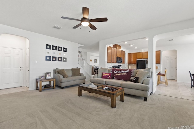 15239 Sirius Cir, San Antonio, TX 78245 - living room featuring arched walkways, light carpet, a ceiling fan, and recessed lighting