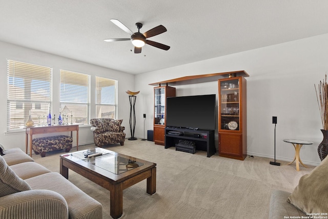 15239 Sirius Cir, San Antonio, TX 78245 - living room featuring ceiling fan, light carpet, and baseboards