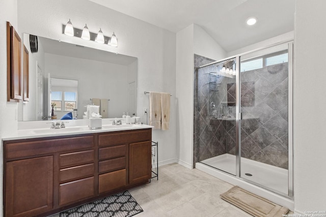 15239 Sirius Cir, San Antonio, TX 78245 - ensuite bathroom with double vanity, a shower stall, and baseboards