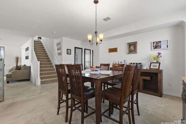 15239 Sirius Cir, San Antonio, TX 78245 - dining area featuring a chandelier, stairway, light colored carpet, and baseboards