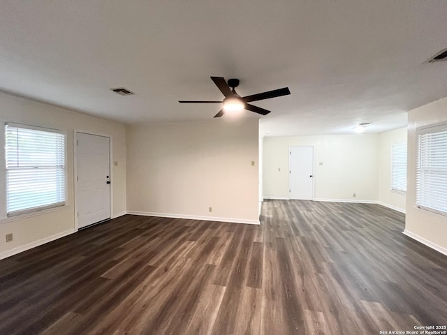 258 Galway, San Antonio, TX 78223 - unfurnished living room featuring dark wood-type flooring, a ceiling fan, and baseboards