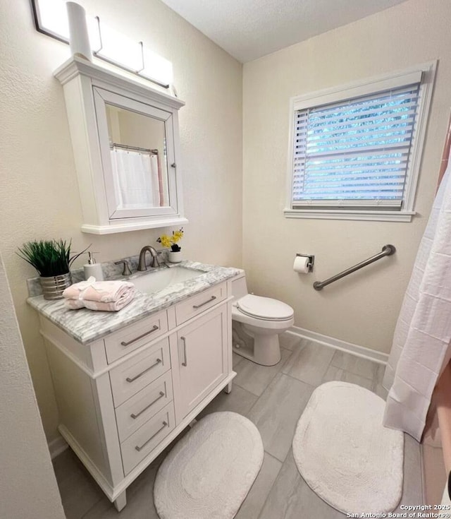 258 Galway, San Antonio, TX 78223 - bathroom featuring toilet, vanity, and baseboards