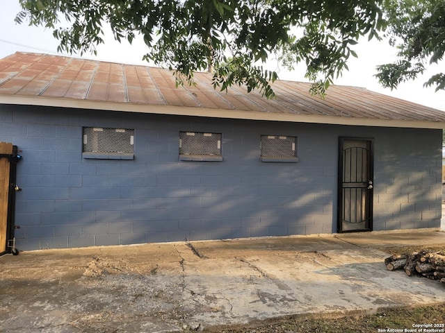 258 Galway, San Antonio, TX 78223 - view of side of home with concrete block siding and metal roof