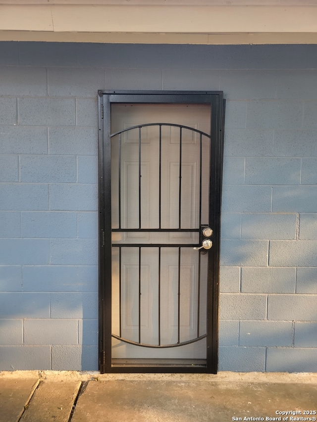 258 Galway, San Antonio, TX 78223 - doorway to property featuring concrete block siding