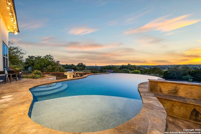 406 Breathless View St, San Antonio, TX 78260 - pool at dusk featuring an infinity pool and a patio