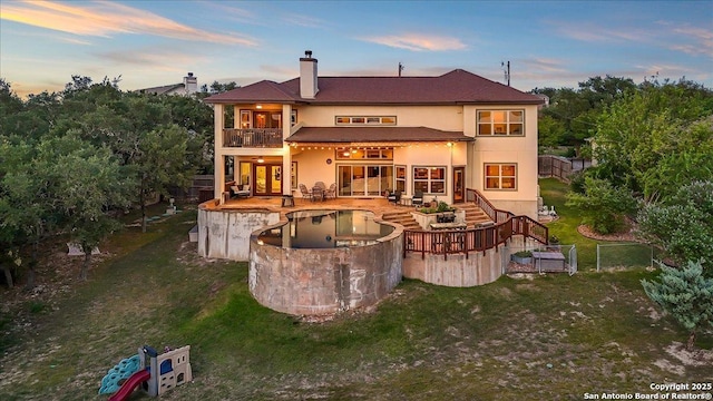 406 Breathless View St, San Antonio, TX 78260 - back of property with a balcony, an outdoor pool, stucco siding, a chimney, and a patio