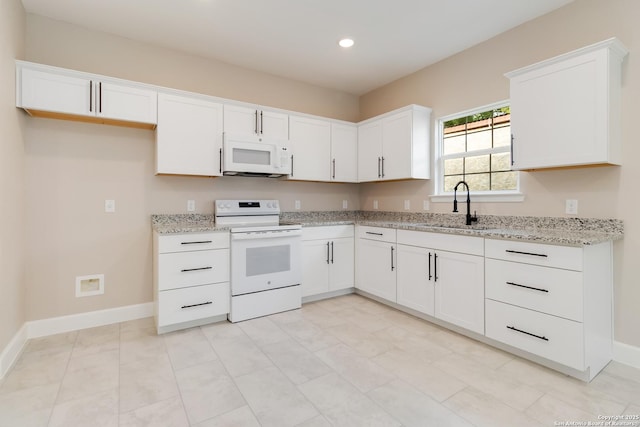 127 Hopi, San Antonio, TX 78211 - kitchen with white appliances, a sink, recessed lighting, white cabinets, and light stone counters