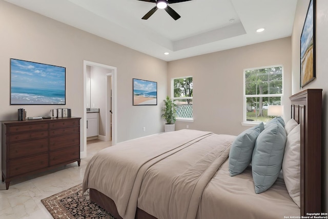 127 Hopi, San Antonio, TX 78211 - bedroom with light marble finish floors, recessed lighting, ensuite bath, a ceiling fan, and a raised ceiling