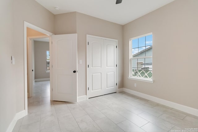 127 Hopi, San Antonio, TX 78211 - unfurnished bedroom featuring baseboards, a ceiling fan, and a closet