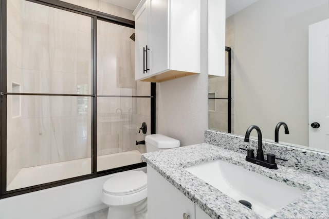 127 Hopi, San Antonio, TX 78211 - bathroom with toilet, vanity, and bath / shower combo with glass door