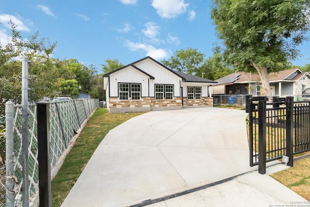 127 Hopi, San Antonio, TX 78211 - view of front of property featuring board and batten siding, brick siding, and concrete driveway