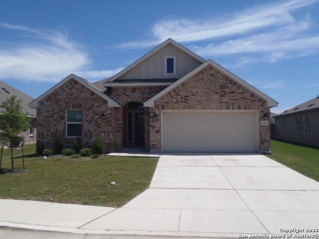 5919 Corsicana, Seguin, TX 78155 - craftsman-style house with board and batten siding, an attached garage, brick siding, and a front yard