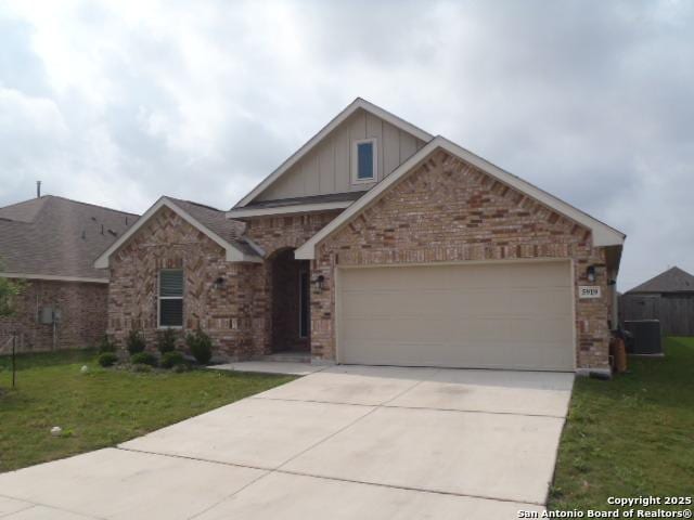 5919 Corsicana, Seguin, TX 78155 - craftsman inspired home featuring board and batten siding, a front yard, brick siding, and concrete driveway