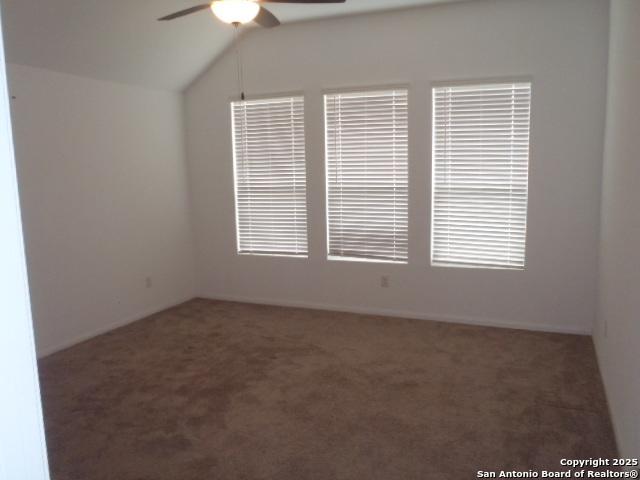 5919 Corsicana, Seguin, TX 78155 - spare room featuring a ceiling fan, carpet floors, and vaulted ceiling