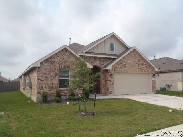 5919 Corsicana, Seguin, TX 78155 - view of front facade featuring board and batten siding, concrete driveway, brick siding, and a garage
