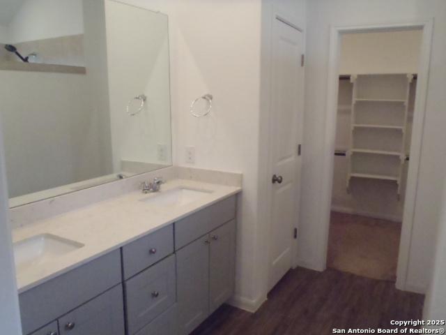 5919 Corsicana, Seguin, TX 78155 - bathroom featuring double vanity, wood finished floors, and a spacious closet