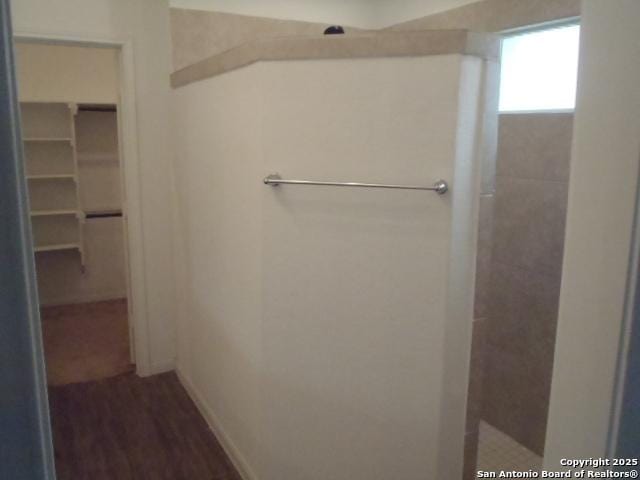5919 Corsicana, Seguin, TX 78155 - full bath featuring a walk in closet, a shower, baseboards, and wood finished floors