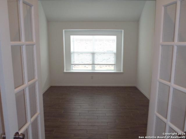 5919 Corsicana, Seguin, TX 78155 - empty room featuring dark wood-type flooring and baseboards