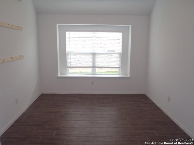 5919 Corsicana, Seguin, TX 78155 - spare room featuring dark wood-style flooring and baseboards