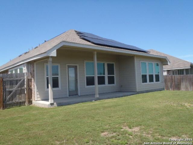 5919 Corsicana, Seguin, TX 78155 - rear view of house featuring roof mounted solar panels and a patio