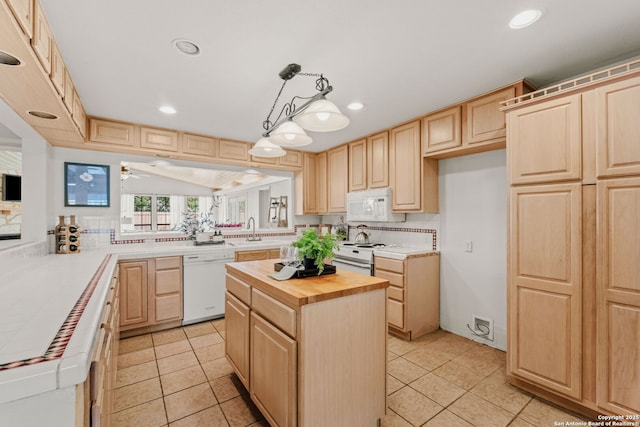 219 Ridgehaven, San Antonio, TX 78209 - kitchen featuring white appliances, light brown cabinetry, wooden counters, recessed lighting, and decorative backsplash