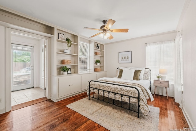 219 Ridgehaven, San Antonio, TX 78209 - bedroom with access to exterior, wood finished floors, crown molding, ceiling fan, and baseboards