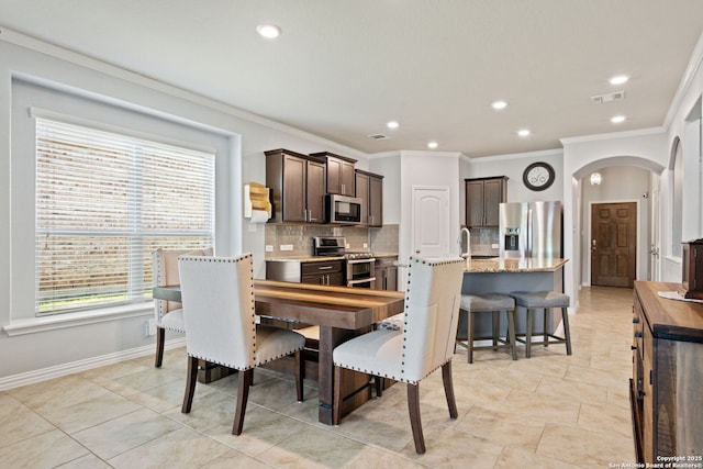 13818 Cohan Way, San Antonio, TX 78253 - dining area featuring arched walkways, crown molding, recessed lighting, and baseboards