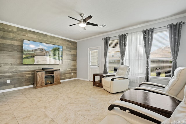 13818 Cohan Way, San Antonio, TX 78253 - living room with wood walls, ornamental molding, baseboards, a ceiling fan, and a warm lit fireplace