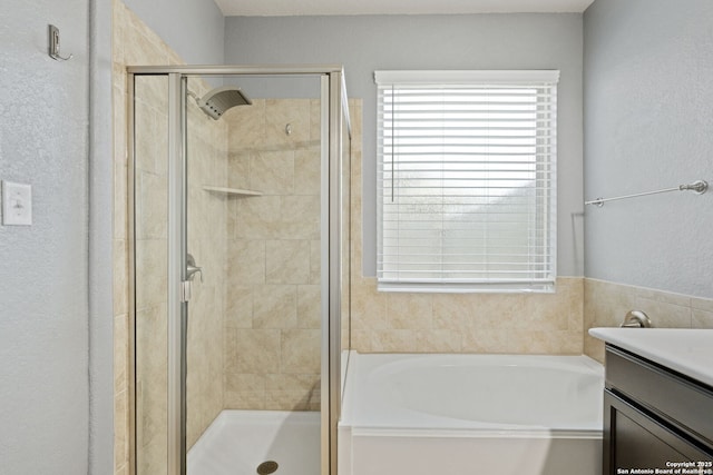 13818 Cohan Way, San Antonio, TX 78253 - bathroom featuring a garden tub, a stall shower, vanity, and a textured wall