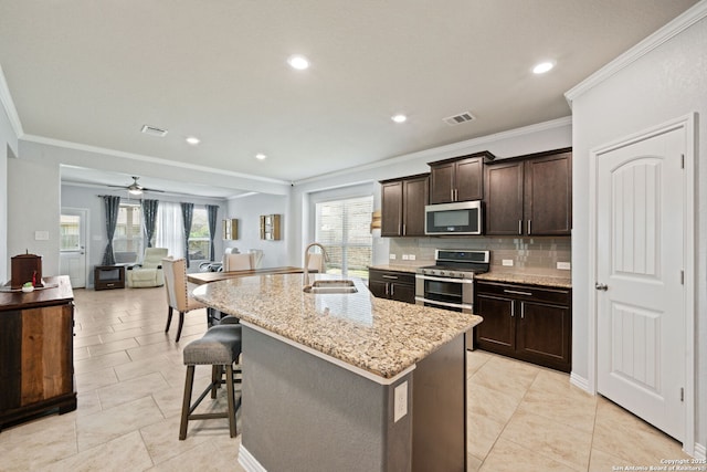 13818 Cohan Way, San Antonio, TX 78253 - kitchen with stainless steel appliances, a sink, crown molding, decorative backsplash, and dark brown cabinetry