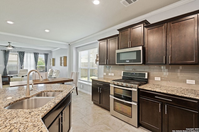 13818 Cohan Way, San Antonio, TX 78253 - kitchen with stainless steel appliances, a sink, crown molding, decorative backsplash, and dark brown cabinetry