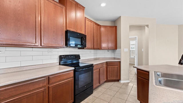 4527 Southton Way, San Antonio, TX 78223 - kitchen with black appliances, a sink, backsplash, light countertops, and light tile patterned floors