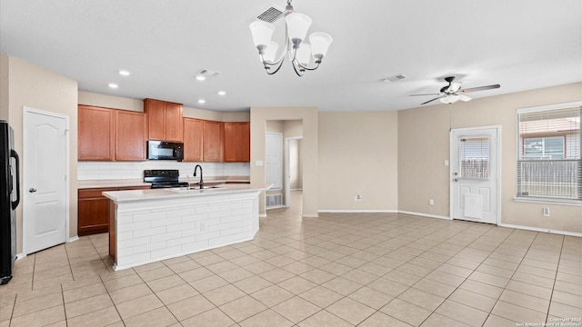 4527 Southton Way, San Antonio, TX 78223 - kitchen featuring black appliances, light countertops, backsplash, a sink, and hanging light fixtures