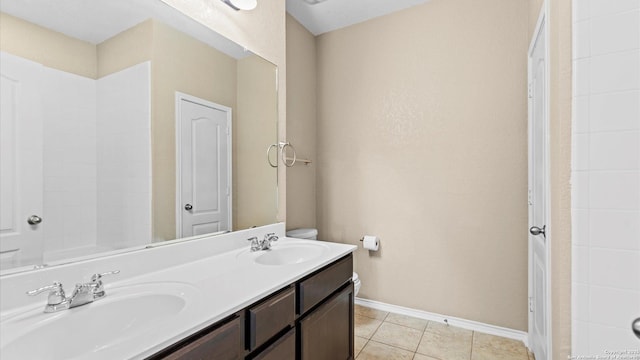 4527 Southton Way, San Antonio, TX 78223 - bathroom with double vanity, baseboards, and tile patterned flooring