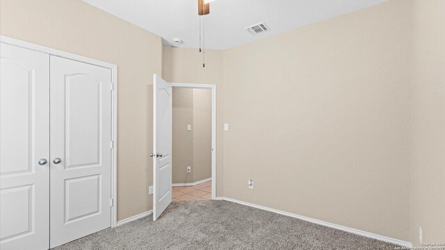 4527 Southton Way, San Antonio, TX 78223 - unfurnished bedroom featuring light carpet, a closet, baseboards, and a ceiling fan