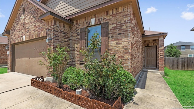 4527 Southton Way, San Antonio, TX 78223 - property entrance featuring brick siding, concrete driveway, and an attached garage