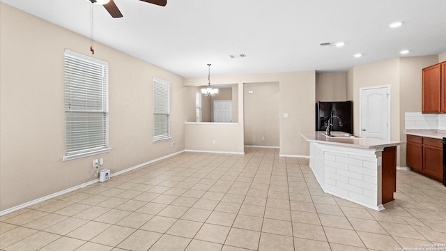 4527 Southton Way, San Antonio, TX 78223 - kitchen with black refrigerator with ice dispenser, ceiling fan, a sink, a chandelier, and light countertops